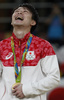 リオデジャネイロ五輪、体操男子個人総合決勝。金メダルを獲得し笑顔を見せる内村航平（2016年8月10日撮影）。(c)AFP/Thomas COEX