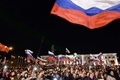 ウクライナ南部クリミア（Crimea）半島のシンフェロポリ（Simferopol）にあるレーニン広場（Lenin Square）で、ロシア編入への賛成が多数を占めた住民投票結果を祝う人々（2014年3月16日撮影）。(c)AFP/DIMITAR DILKOFF