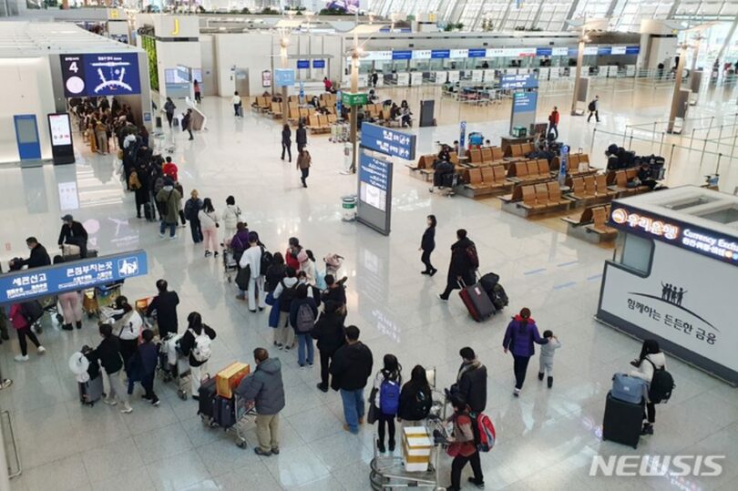 12月28日午後、仁川国際空港第1旅客ターミナルで年末を迎え、出国場の前に長い列ができている(c)NEWSIS