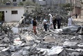 パレスチナ自治区ガザ地区（Gaza Strip）南部ラファ（Rafah）の難民キャンプ近くで、イスラエル軍の攻撃で破壊された建物のがれきの中を避難するパレスチナ人（2014年8月4日撮影）。(c)AFP/MAHMUD HAMS