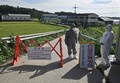 韓国の坡州市で、アフリカ豚コレラに感染した養豚場への立ち入りを防ぐため道路を封鎖する検疫当局者（2019年9月17日撮影）。(c)Jung Yeon-je / AFP