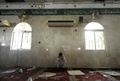 サウジアラビア東部州のカティーフで、爆発があったイスラム教シーア派のモスク内でうなだれる男性（2015年5月22日撮影）。(c)AFP