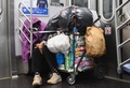 米ニューヨークの地下鉄車内で眠るホームレス（2020年4月29日撮影）。(c)Angela Weiss / AFP