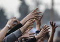 食料や日用品をつかもうとする難民や移民。(c)AFP/Bulent Kilic