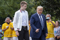 バロン・トランプさん（中央左）とドナルド・トランプ米大統領（中央右、2020年8月16日撮影、資料写真）。(c)Eric BARADAT / AFP