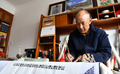 自宅でサンスクリット語を書く久米次成（ＧｙｕｍｅｙＴｓｕｌｔｒｉｍ）さん（2023年4月19日撮影）。(c)Xinhua News