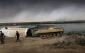 イラク第2の都市モスルの南方に位置するケイヤラで、イスラム過激派組織「イスラム国（IS）」を駆逐した後に戦車のそばを歩くイラク部隊の隊員（2016年8月31日撮影）。(c)AFP/SAFIN HAMED