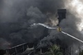 バングラデシュ・ダッカ郊外のトンギで、爆発による火災が起きた工場で消火活動にあたる消防隊員（2016年9月10日撮影）。(c)AFP/RAJIB DHAR