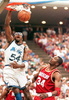 Orlando Magic forward Horace Grant(L) dunks the ball as Houston Rockets center Hakeem Olajuwon watches 07 June during first quarter action of game one of the NBA Championships in the Orlando Arena. (c)AFP/CALVIN KNIGHT