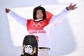 北京冬季五輪、スノーボード男子ハーフパイプ決勝。金メダルを獲得し、表彰式で国旗を手にする平野歩夢（2022年2月11日撮影）。(c)Marco BERTORELLO / AFP