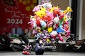 ベトナム・ハノイの道路脇で風船を買い求める客を待つ売り子（2024年2月15日撮影）。(c)Nhac NGUYEN / AFP