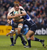 ラインスターの選手からタックルを受けるトゥールーズの%%Romain Millo-Chlusky%%（中央）。(c)AFP/PETER MUHLY