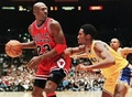 Michael Jordan of the Chicago Bulls (L) eyes the basket as he is guarded by Kobe Bryant of the Los Angeles Lakers during their 01 February game in Los Angeles, CA. (c)AFP/Vince BUCCI