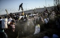 トルコ・アクチャカレの国境検問所付近で、壊された国境のフェンスを越えてトルコ領内に入ろうとするシリア難民たち（2015年6月14日撮影）。(c)AFP/BULENT KILIC