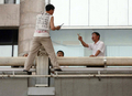 中国・北京（Beijing）の鉄道駅で15日、同国・黒竜江（Heilongjiang）省の役人の不正を訴えるTシャツを着た男が橋に上り、自ら手を切りつけた後で、飛び降りて抗議の意思を示すと訴えた。写真は、説得を試みる当局者ら（2009年6月15日撮影）。(c)AFP