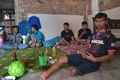 インドネシア・西ジャワ州のインドラマユで行われたフットサルの試合前、チームメートや友人と休息するエマン・スラエマンさん（右、2018年2月3日撮影）。(c)AFP PHOTO / ADEK BERRY