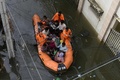 インド・ハイデラバードの豪雨で冠水した通りで、ボートを使って住民を避難させる国家災害対応部隊の隊員ら（2020年10月15日撮影）。(c)NOAH SEELAM / AFP