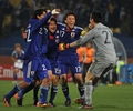 2010年サッカーW杯南アフリカ大会（%%2010 World Cup%%）1次リーグE組、デンマーク対日本。日本は3-1で勝利し、勝ち点6（2勝1敗）の同組2位で決勝トーナメントに進んだ。日本の決勝トーナメント進出は、自国開催以外のW杯では初めて。写真はチームメイトと勝利を喜ぶ日本の川島永嗣（%%Eiji Kawashima%%、右）。（2010年6月24日撮影）(c)AFP/ROBERTO SCHMIDT
