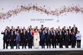 大阪で開催中の20か国・地域（G20）首脳会議の歓迎行事で、記念撮影に臨む参加国・国際機関の代表者（2019年6月28日撮影）。(c) Brendan Smialowski / AFP