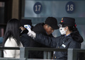 中国・北京の駅で乗客の体温を測る職員（2020年2月1日撮影）。(c)NOEL CELIS / AFP