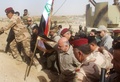 イラク政府軍がイスラム過激派組織「イスラム国」から奪還した同国西部カイムで、国旗を立てるアバディ首相（中央、2017年11月5日撮影）。(c)AFP/MOADH AL-DULAIMI