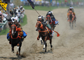 福島県の伝統祭り「相馬野馬追」は29日に2日目を迎え、東日本大震災の影響で前年は見送られていた主行事の甲冑（かっちゅう）競馬と神旗争奪戦が南相馬市で行われた。1000年にわたり続く祭りにはこの日、数万人が訪れ、約400騎が繰り広げる勇壮な伝統行事を楽しんだ。

写真は甲冑競馬で競り合う騎馬武者たち（2012年7月29日撮影）。(c)AFP/Toru YAMANAKA