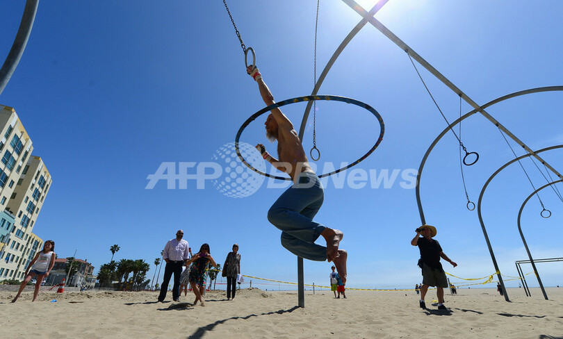 フラフープしながらつり輪のギネス記録、米51歳男性が目指す