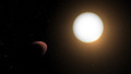 欧州宇宙機関（ESA）が公開した、ラグビーボールのように変形した太陽系外惑星「WASP-103b」（左）の想像図（2022年1月11日公開）。(c)AFP PHOTO /European Space Agency
