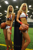 米国で、下着姿でアメリカンフットボールをする「ランジェリーフットボール（Lingerie Football）」の全米リーグが、今年9月に開幕する。「ランジェリーフットボールリーグ（Lingerie Football League、LFL）」は、全米10チームが20週のシーズンを戦う。14日、ニューヨーク（New York）市近郊のフリーポート（Freeport）で行われたニューヨーク・マジェスティ（New York Majesty）の入団テストには、24人の若い女性が参加し、露出度の高い運動着を着てフットボールの技能を競い合った。写真は、入団テスト前に写真撮影に応じるLFL選手のEther Greyさん（左）とMelissa Teixeiraさん（2009年5月14日撮影）。(c)AFP/Emmanuel Dunand