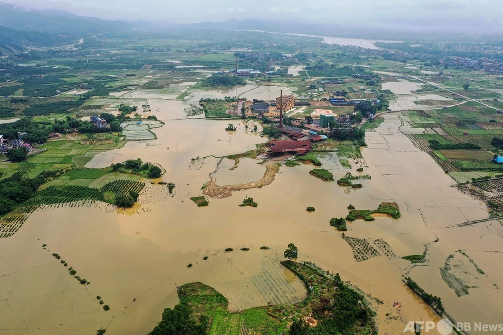 中国南部、豪雨による洪水 田畑や製材所が冠水