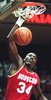 Houston Rocket Hakeem Olajuwon hits slams for two points during first period action of his NBA game, 26 December 1994, in Miami. (c)AFP/DOUG COLLIER