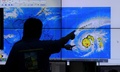 フィリピン・マニラにある同国気象庁で台風4号の進路を監視する気象学者（2015年4月1日撮影）。(c)AFP/Jay DIRECTO