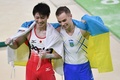 リオデジャネイロ五輪、体操男子個人総合決勝。銀メダリストのオレグ・ベルニャエフ（右）と肩を組む内村航平（2016年8月10日撮影）。(c)AFP/Ben STANSALL