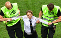 ロシアの首都モスクワで行われたサッカーW杯ロシア大会の決勝中に、警察官の扮装（ふんそう）でピッチに乱入したロシアの反体制派パンクバンド「プッシー・ライオット」のメンバー（2018年7月15日撮影）。(c)AFP PHOTO / Mladen ANTONOV 