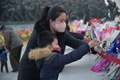 北朝鮮・平壌の万寿台で、金正日氏と日成氏の銅像に花を手向ける市民（2021年12月16日撮影）。(c)KIM Won Jin / AFP