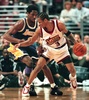 The Philadelphia 76ers point guard Allen Iverson (R) smiles as he moves past the Los Angeles Lakers Kobe Bryant (L) on his way to the basket 19 March 1999 in Philadelphia. (c)AFP/TOM MIHALEK