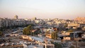 シリア北部アレッポの反体制派支配地区と、政権側支配地区（奥）を結ぶ回廊（中央、2016年7月29日撮影）。(c)AFP/KARAM AL-MASRI