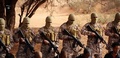 イスラム過激派組織「イスラム国」が公開した、リビアで拘束され、覆面の戦闘員らの前にひざまずくエチオピア人のキリスト教徒らを写したとする動画からの一こま（2015年4月19日取得）。(c)AFP/HO/AL-FURQAN MEDIA