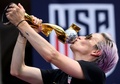 米ニューヨークで行われた女子サッカーW杯優勝パレードで優勝トロフィーにキスをする米国代表のミーガン・ラピノー（2019年7月10日撮影）。(c)Johannes EISELE / AFP