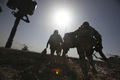 アフガニスタン南部ヘルマンド（Helmand）州マルジャ（Marjah）で、ヘリコプターに向かって走る米海兵隊員（2010年2月17日撮影）。(c)AFP/Altaf Qadri