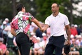 男子ゴルフのメジャー第1戦、第87回マスターズ・トーナメント初日。18番を終えてビクトル・ホブランド（左）と握手を交わすタイガー・ウッズ（2023年4月6日撮影）。(c)Ross Kinnaird/Getty Images/AFP