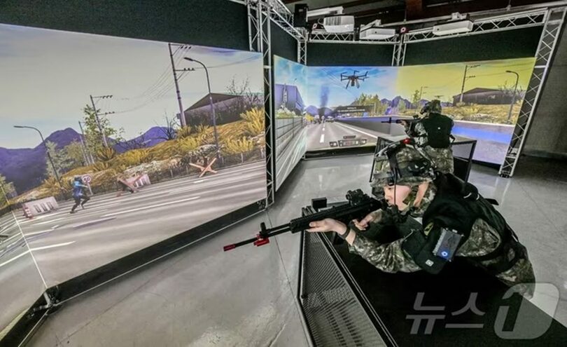 3面マルチスクリーンを使ったVR映像模擬射撃訓練を受ける予備軍(c)news1