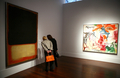 2007年11月12日、ニューヨーク（New York）でクリスティーズ（Christie&apos;s）のオークションに出品されたマーク・ロスコ（Mark Rothko）の作品「No7 （Dark Over Light、左）」の値段をのぞき込む入場者。事前予想額は2000-3000万ドル（約22-33億円）。右に見えるのはウィレム・デ・クーニング（Willem de Kooning）の作品で、落札予想価格は1600-1900万ドル（約18億-22億円）。(c)AFP/Emmanuel DUNAND