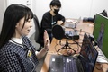 Vチューバー、琴吹ゆめの「中の人」として活動する飯塚麻結さん（手前）。都内のスタジオで（2022年4月7日撮影）。(c)Charly TRIBALLEAU / AFP