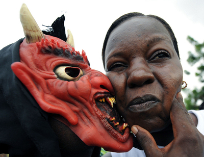 コートジボワールのカーニバル、悪魔も浮かれてキス