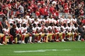 17NFL第4週、サンフランシスコ・フォーティナイナーズ対アリゾナ・カーディナルス。試合前の国歌演奏で膝立ちになるサンフランシスコ・フォーティナイナーズの選手（2017年10月1日撮影）。(c)AFP/Getty Images/Norm Hall
