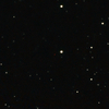 欧州南天天文台（European Southern Observatory、ESO）が公開した、観測データから作成したクエーサー「ULAS J1120+0641」（中央付近の小さな赤い点）の画像（2011年6月29日提供）。(c)AFP/ESO/UKIDSS/SDSS