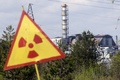 ウクライナ・チェルノブイリ原発前に立てられている放射能の標識。この写真が撮影された時点で同原発付近の森林火災はほぼ鎮火していた（2015年5月1日撮影）。(c)AFP/ANATOLII STEPANOV