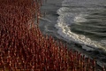 オーストラリア・シドニーのボンダイ・ビーチで、写真家スペンサー・チュニック氏による皮膚がんを啓発するアートイベントにヌードで参加した人々（2022年11月26日撮影）。(c)Saeed KHAN / AFP