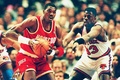 Houston Rockets&apos; Hakeem Olajuwon (34) looks to pass the ball under defensive pressure from the New York Knicks&apos; Patrick Ewing during the first quarter of the fifth game of the NBA Finals at Madison Square Garden 17 June 1994. (c)AFP/BOB STRONG